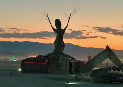 large sculpture of tree spirit rising from fallen robot